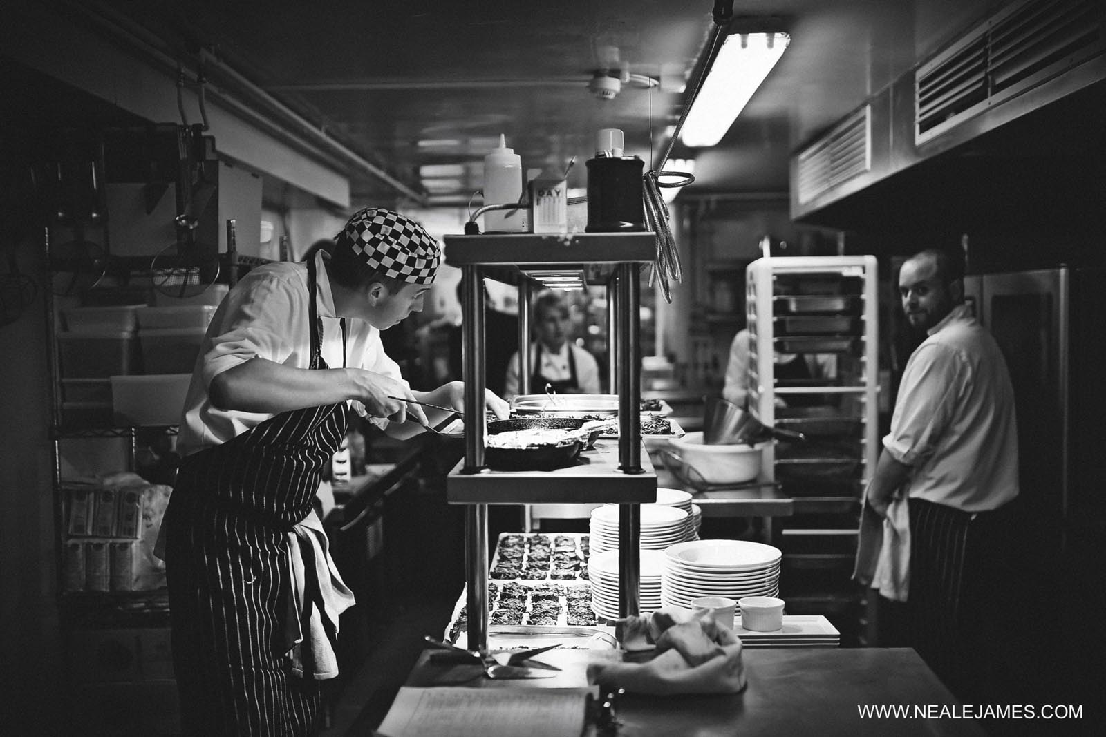 Chefs plating up food for an event at Farnham Castle