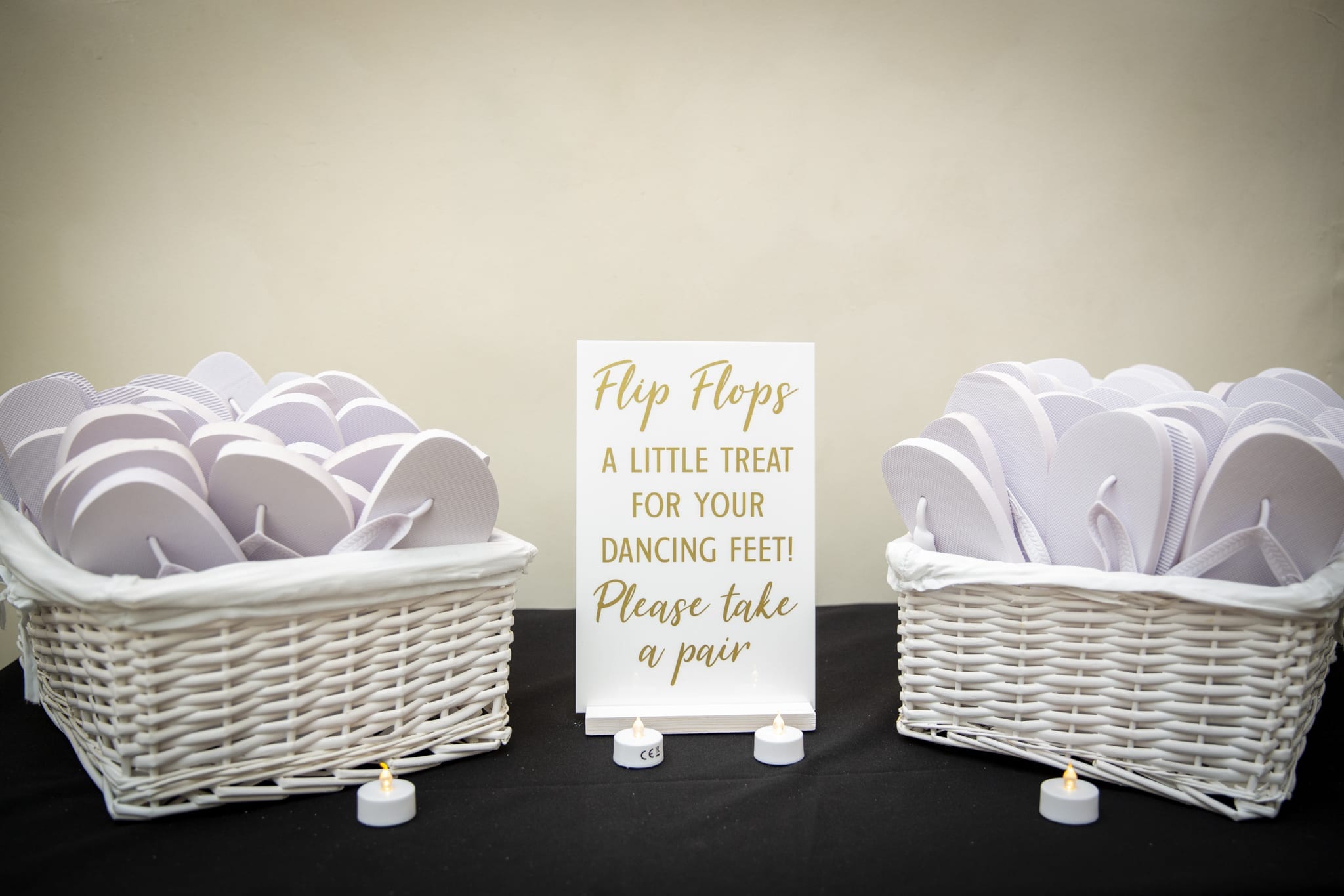 Flip flops in baskets for wedding reception guests at Farnham Castle