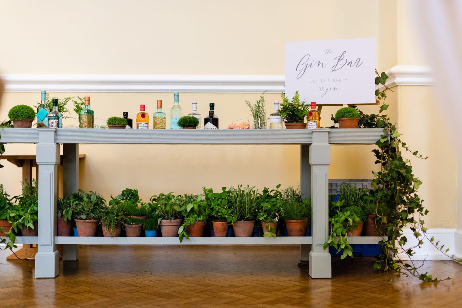 A gin bar at Farnham Castle set up with several types of gin and a range of botanicals
