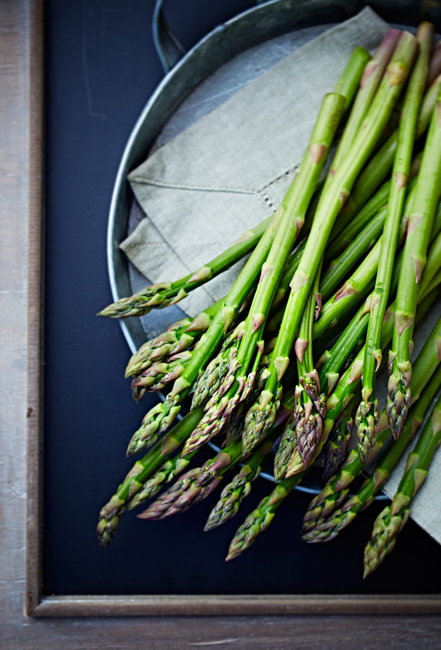 Fresh green asparagus on a serving platter