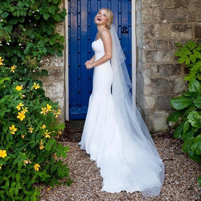 Bride laughing in the garden at Farnham Castle