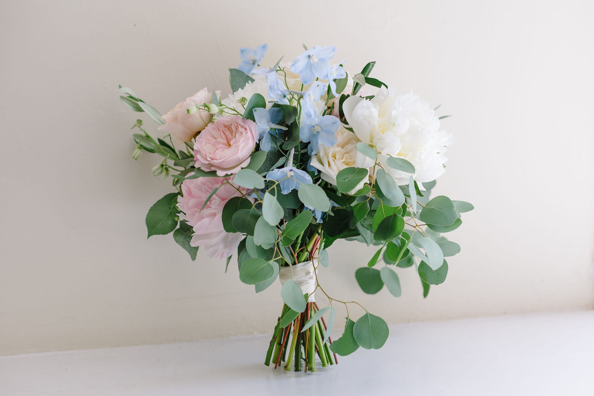 Loosely tied pastel coloured bridal bouquet