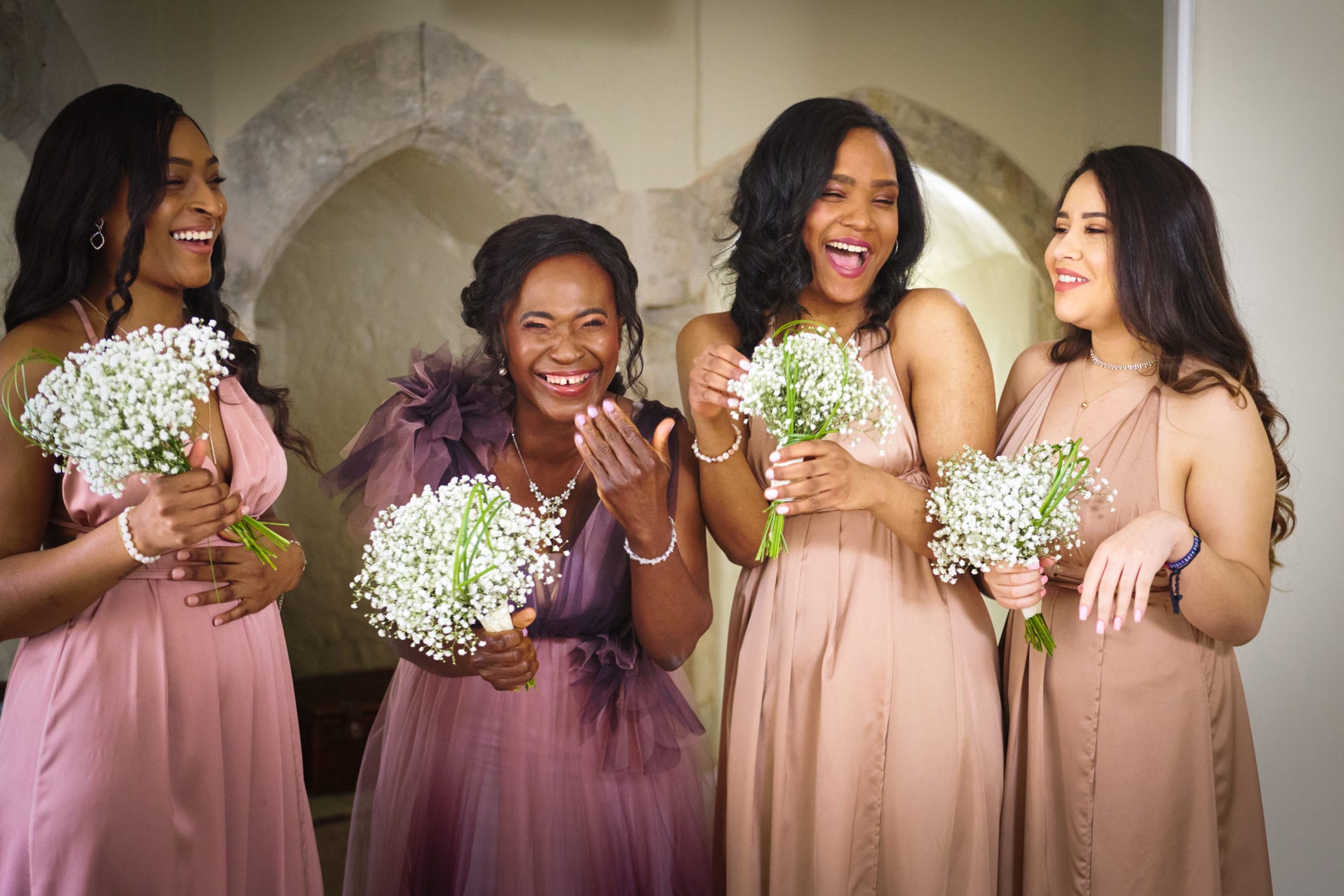 Bridesmaids wearing lilac and peach at Farnham Castle