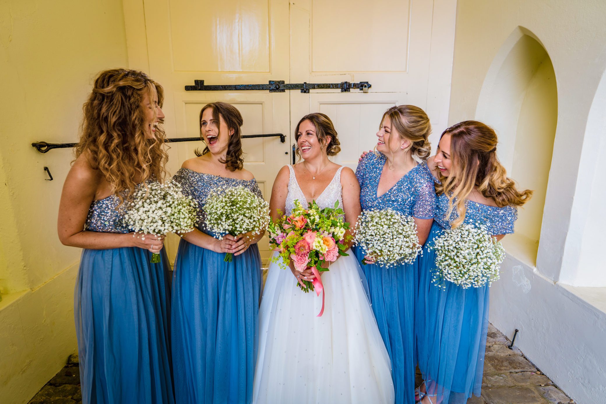 Bridesmaids in long blue dresses