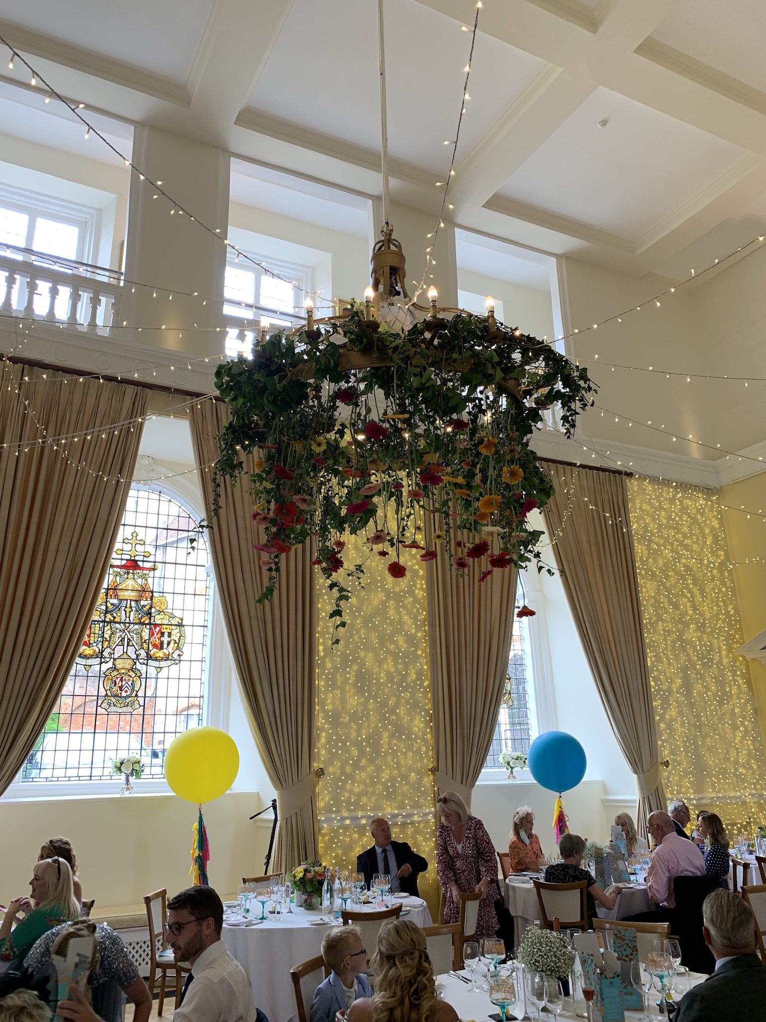 Floral decor hanging from chandelier