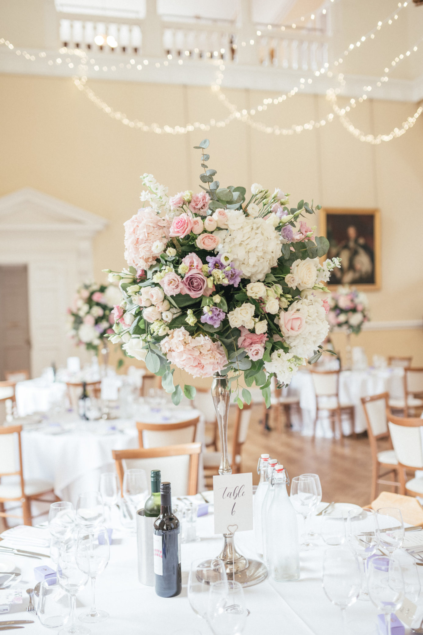 Elegant wedding reception decor in the Great Hall at Farnham Castle in Surrey