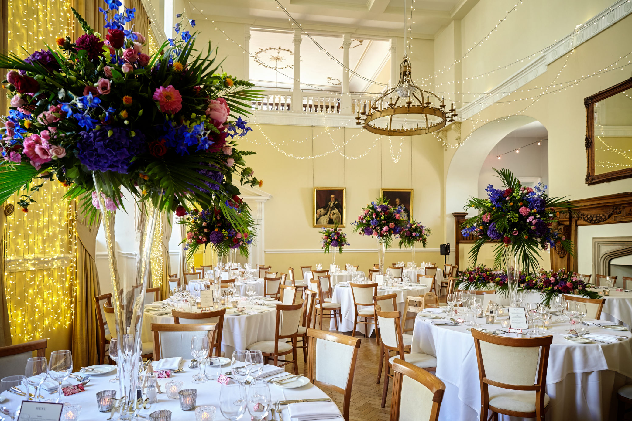 High wedding flowers in vases at Farnham Castle in Surrey