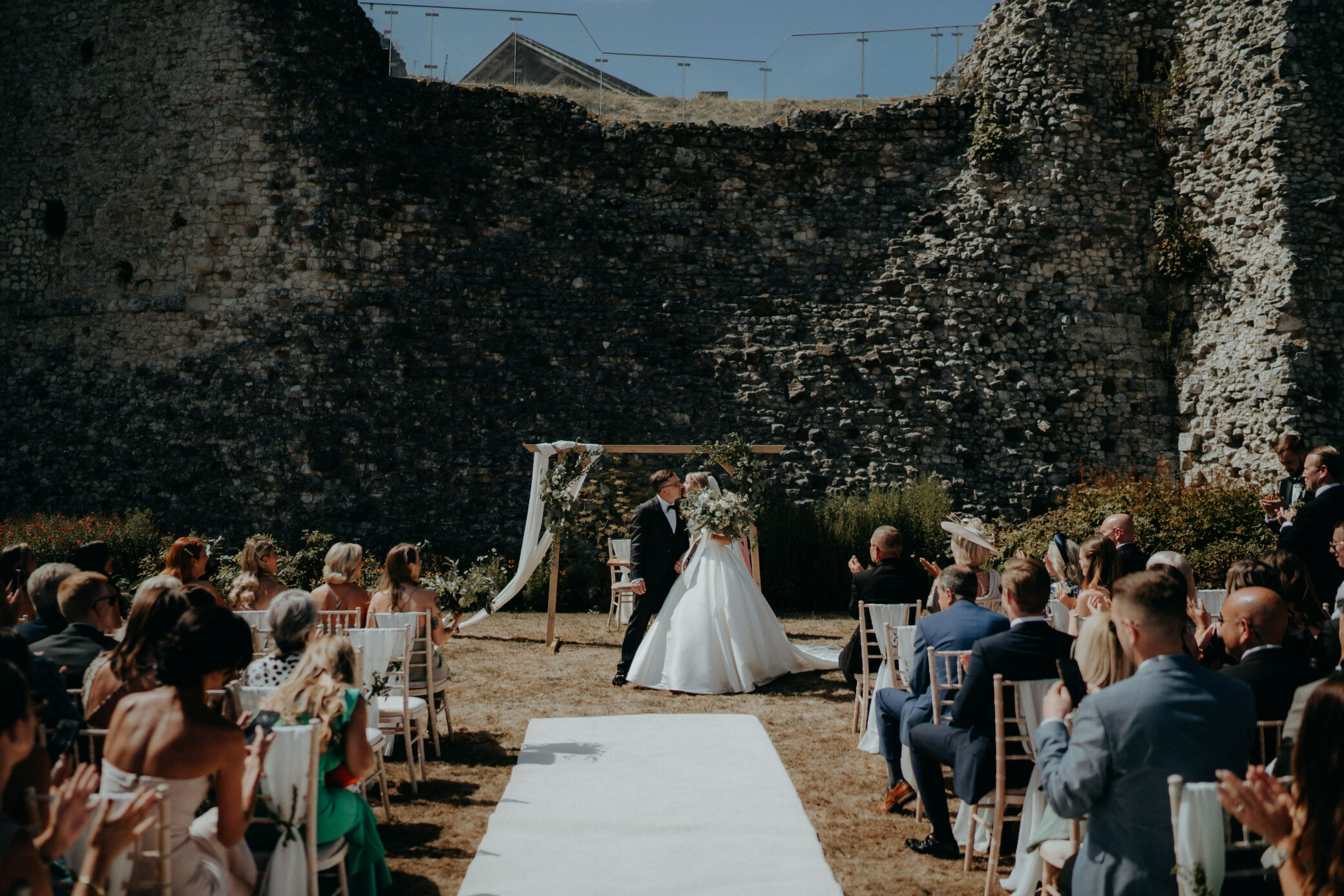 Outdoor wedding ceremony by Farnham Castle Keep in Surrey